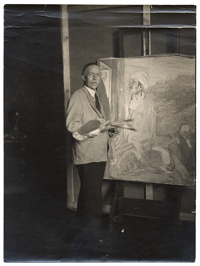 Photograph of Henry Ossawa Tanner with palette and his painting Judas on an easel, 192- / L. Matthes, photographer. Archives of American Art, Smithsonian Institution.